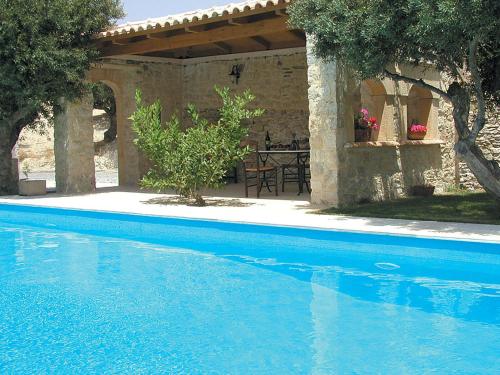 a swimming pool in front of a house at Sprawling Vlilla in Malades in Áyios Síllas