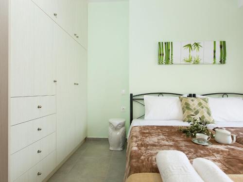 a bedroom with two beds with white cabinets at Villa in Arkadi with Pool near the Sea in Kiriánna