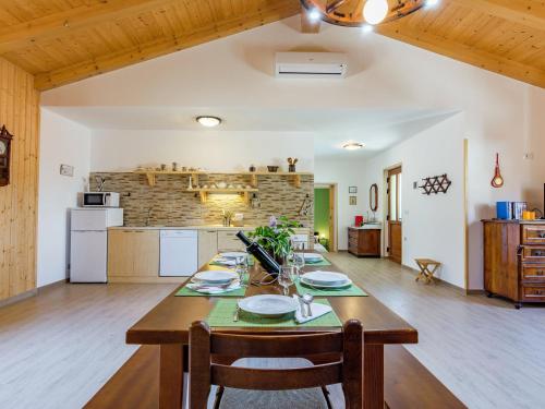 a kitchen and dining room with a large wooden table at Apartment in Istria with Nature Views in Cerovlje