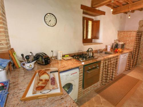a kitchen with a sink and a washing machine at Cottage in Umbria with pool in Casella