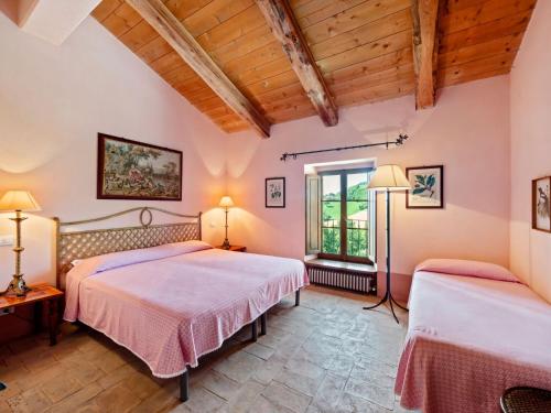 2 camas en una habitación con techos de madera en Belvilla by OYO Locanda le Querce, en Frontino