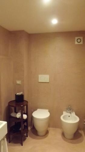 a bathroom with a toilet and a sink at Relais Real Collegio in Noli