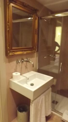 a bathroom with a sink, toilet and shower at Relais Real Collegio in Noli