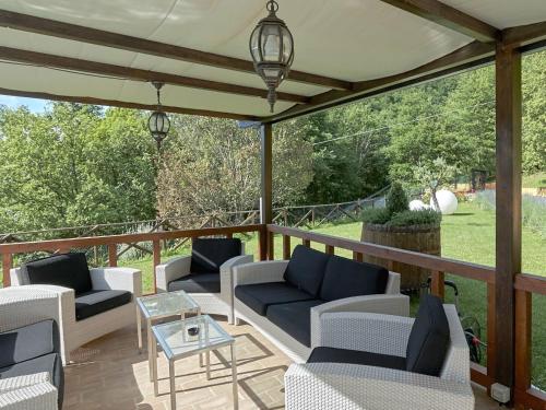 a patio with couches and a table on a deck at Belvilla by OYO Villa Valtopina in Valtopina