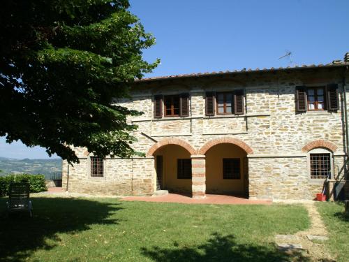 an old stone house with a tree in the foreground at Holiday home in Dicomano FI in Dicomano