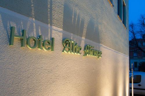 a sign on a building that reads hotel all lit up at Gasthaus Alte Münze in Zwickau