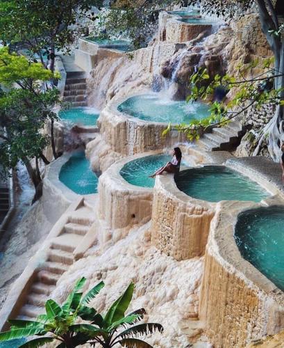 a group of three pools of water on a hill at Hospedaje Tolantongo in Cardonal