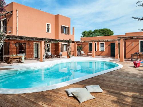a swimming pool in front of a house at Belvilla by OYO Villa Arangea Dieci in Marsala