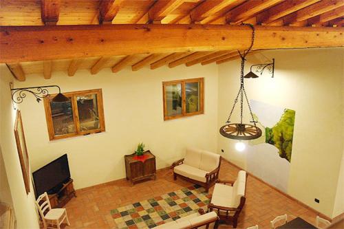 a living room with a couch and a tv at Agriturismo BioBiò in Vobarno