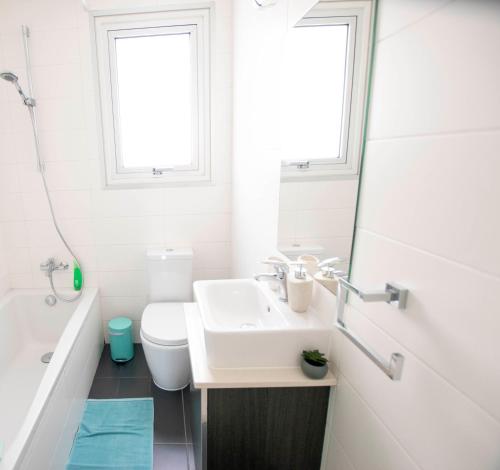 a bathroom with a sink and a toilet and a tub at Glabur Stays - The Fabulous 2 BDR - Nicosia City, Free Parking & Wifi, Welcomes You!!! in Nicosia