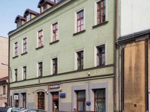 un edificio verde con ventanas en una calle en Modern apartment near Krakow s Old Town, en Cracovia