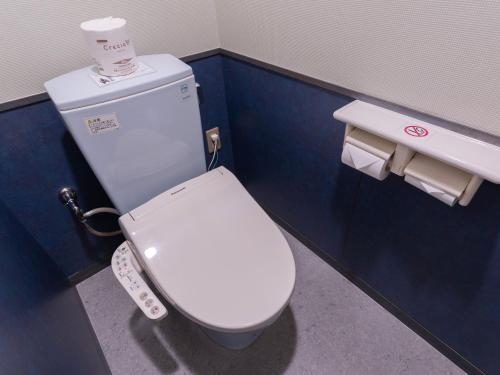 a bathroom with a white toilet and a sink at Hotel Sunset Terrace in Chatan