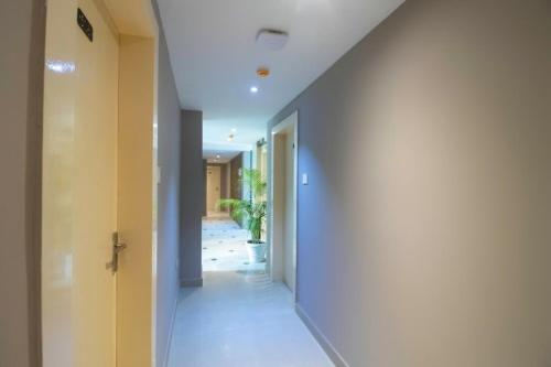 a hallway of a house with a white wall at Hotel Mayfair Tower in Kolkata