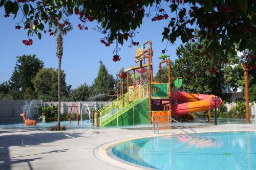 a water park with a slide and a playground at Mayfair Hotel in Paphos City