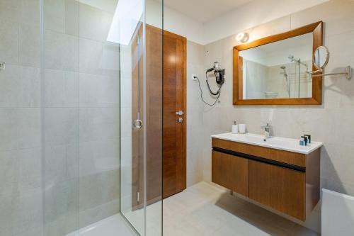 a bathroom with a sink and a shower at Rubicon Garni Hotel in Kragujevac