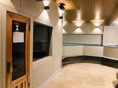 a room with a swimming pool and lights on the wall at Single inn- KAOHSIUNG LINSEN in Kaohsiung