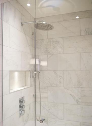 a shower stall with a glass door with a shower at Villa LadyWell in Fethiye