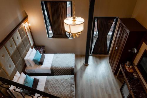 an overhead view of a bedroom with two beds and a mirror at Hotel The Pera Hill in Istanbul