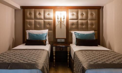 a hotel room with two beds and a headboard at Hotel The Pera Hill in Istanbul