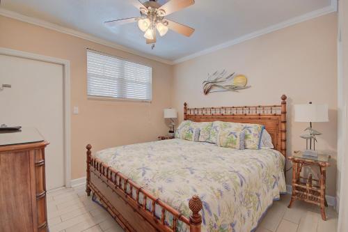a bedroom with a bed and a ceiling fan at Clearwater Beach Suites 102 condo in Clearwater Beach