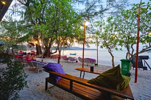 a group of benches sitting on the beach at Onederz Koh Rong Sanloem in Koh Rong Sanloem