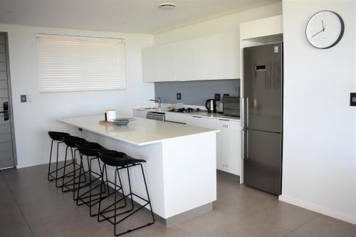 a kitchen with a white counter and a refrigerator at Pebble Beach 301 Penthouse, Sibaya in Sibaya
