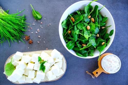 a bowl of spinach and a bowl of tofu and a salad at At Herbal Boutique Hotel & Spa in Protaras