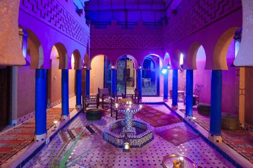 a purple room with a fountain in the middle at Kasbah Rayane Ait Ben Haddou in Aït Ben Haddou