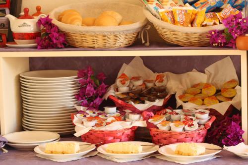 a shelf with baskets of food and baskets of food at Hotel Belvir in Villasimius