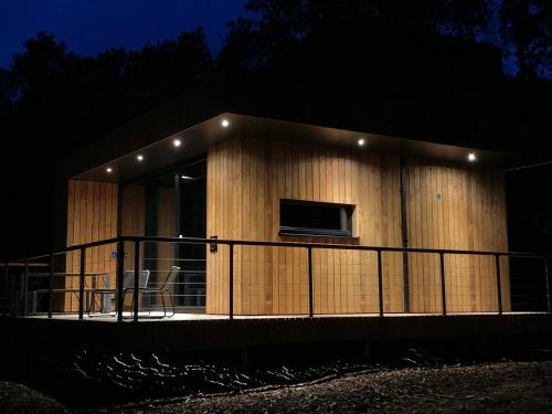 a large building with a balcony at night at Forest Cube in Oignies-en-Thierache