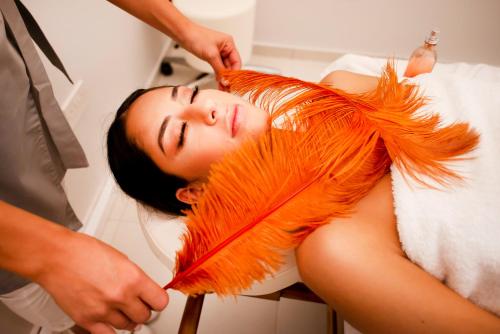 a woman is getting her hair brushed by a man at At Herbal Boutique Hotel & Spa in Protaras
