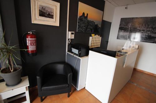 a black office with a black chair and a fire extinguisher at Hostal Fornet Altea in Altea