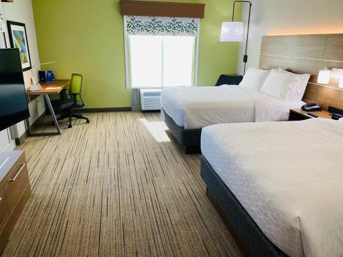 a hotel room with two beds and a desk and a window at Holiday Inn Express & Suites - Enterprise by IHG in Enterprise