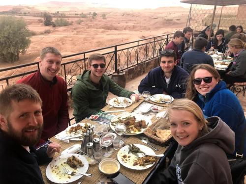 a group of people sitting at a table eating food at Kasbah Rayane Ait Ben Haddou in Aït Ben Haddou