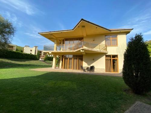 a large house with a lawn in front of it at Aquamarine Hotel&Spa in Plyakho