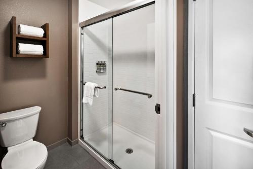 a shower stall in a bathroom with a toilet at Staybridge Suites Irvine - John Wayne Airport by IHG in Irvine
