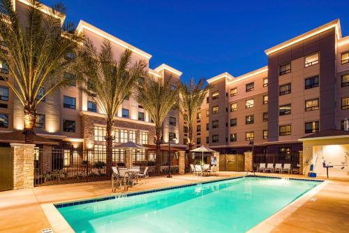 a swimming pool in front of a building at Staybridge Suites Irvine - John Wayne Airport by IHG in Irvine