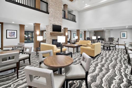 a hotel lobby with chairs and a waiting room at Staybridge Suites Irvine - John Wayne Airport by IHG in Irvine
