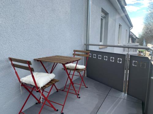 a small table and two chairs on a balcony at ARGENTA Living 2 in Fulda