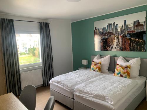 a bedroom with a large bed and a large window at ARGENTA Living 2 in Fulda