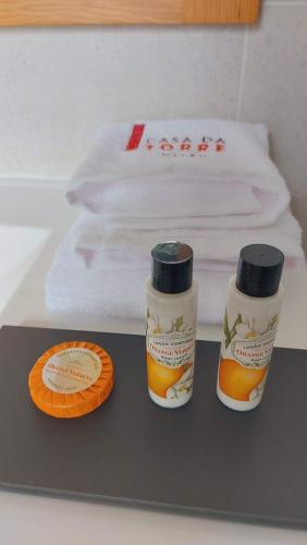 two bottles of orange sauce sitting on a table at Casa da Torre - Viseu in Viseu