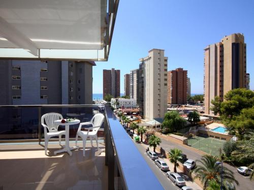 a balcony with two chairs and a table on a building at Hotel Perla in Benidorm