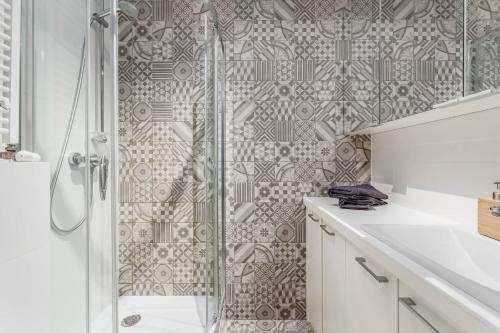 a bathroom with a shower and a sink at Chill Apartments Wola Center in Warsaw