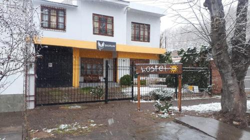 a building with a sign in front of it at SIGRUM Hostel in San Rafael