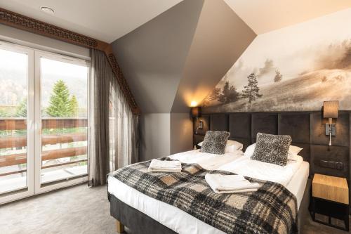 Posteľ alebo postele v izbe v ubytovaní Apartament Giewont House & Spa z Sauną Zakopane