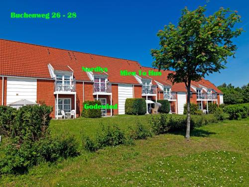 a building with green signs on the side of it at Godewind in Insel Poel