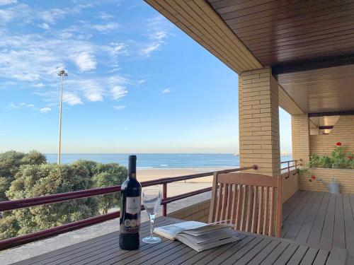 a bottle of wine sitting on a table on a balcony at Own Places - Ocean View Apartment in Matosinhos