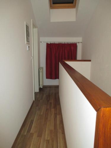 a hallway with a red curtain and a red window at Studio Brnat in Kobarid