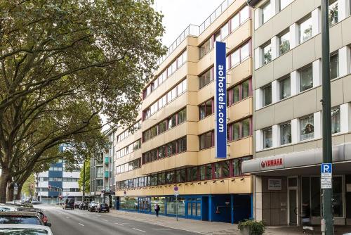 a building with a blue sign on the side of it at a&o Düsseldorf Hauptbahnhof in Düsseldorf
