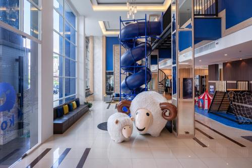 two large stuffed animals standing in a lobby at Kokotel Bangkok Dheva Thonglor in Bangkok